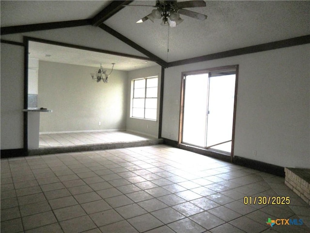 empty room featuring vaulted ceiling with beams and ceiling fan with notable chandelier