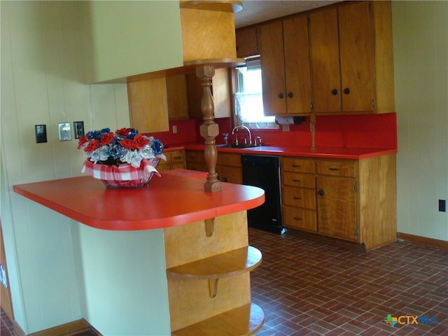 kitchen featuring kitchen peninsula, sink, and black dishwasher