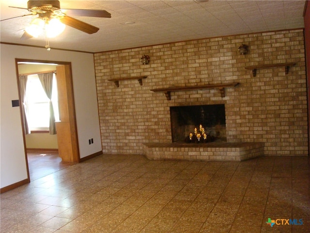 unfurnished living room featuring a fireplace, ceiling fan, and brick wall