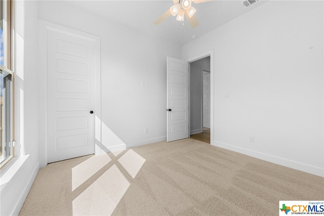 carpeted empty room with ceiling fan