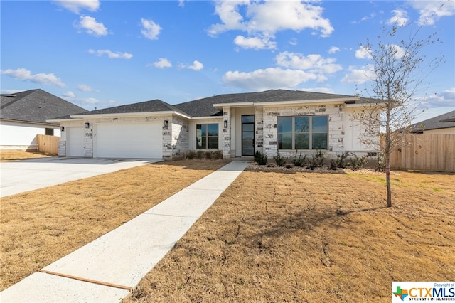 view of front of property with a front yard and a garage