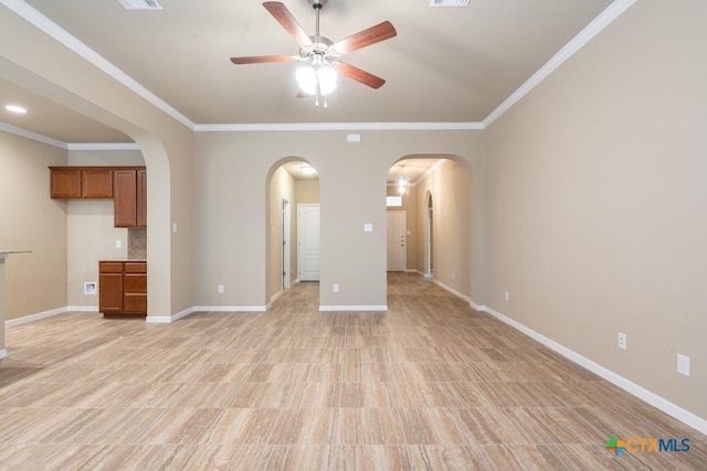 unfurnished living room with ornamental molding and ceiling fan