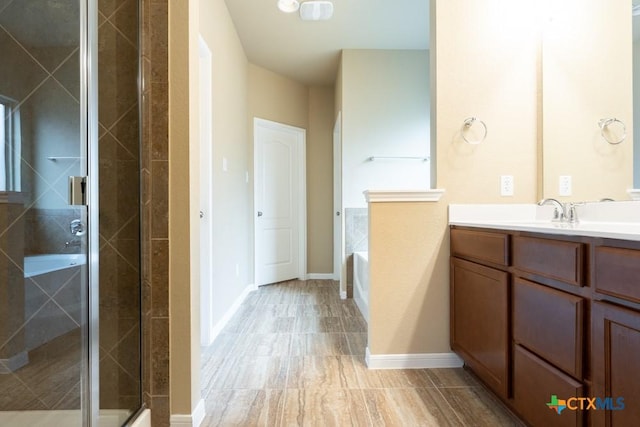 bathroom with independent shower and bath and vanity