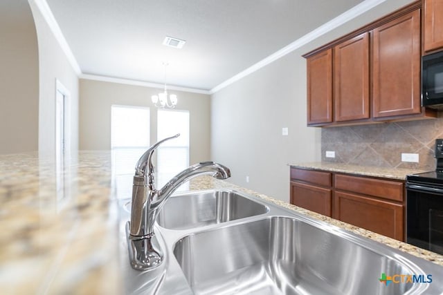 kitchen featuring sink, ornamental molding, light stone countertops, decorative backsplash, and black appliances