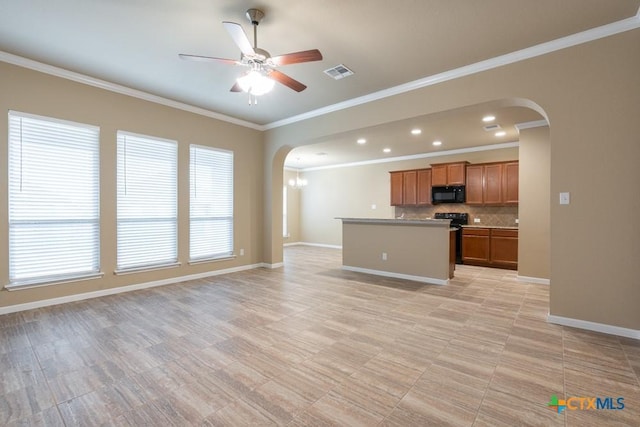 kitchen featuring tasteful backsplash, ornamental molding, a kitchen island, and ceiling fan