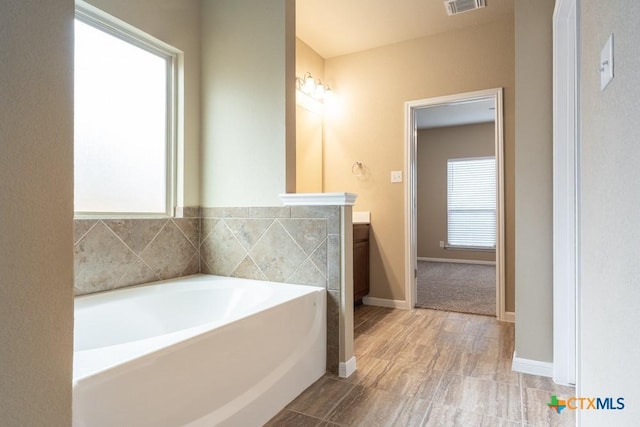 bathroom with vanity and a bathtub