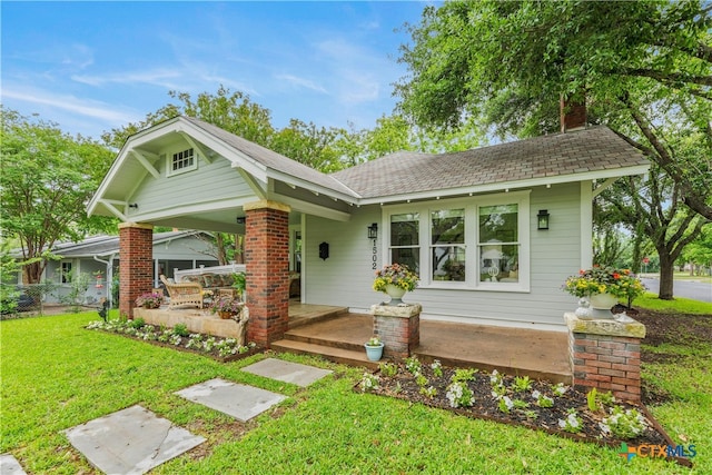 view of front of home with a front lawn and covered porch