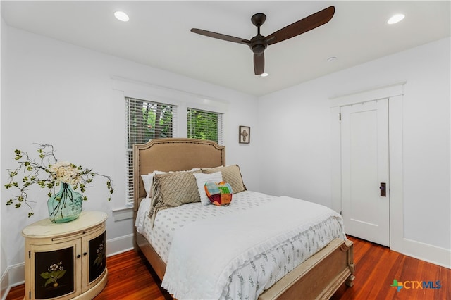 bedroom with ceiling fan and dark hardwood / wood-style flooring