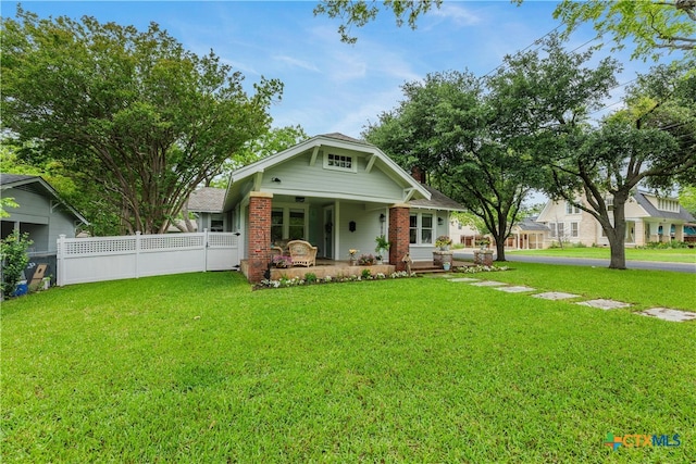 view of front facade with a front lawn and a porch