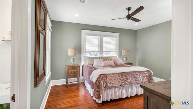 bedroom featuring ceiling fan and dark hardwood / wood-style floors