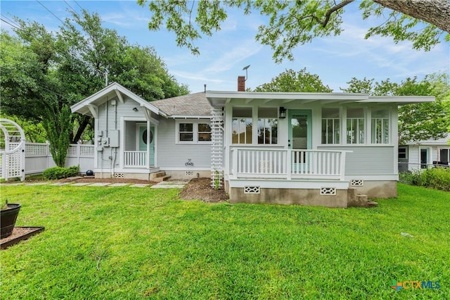 back of house with a yard and a porch