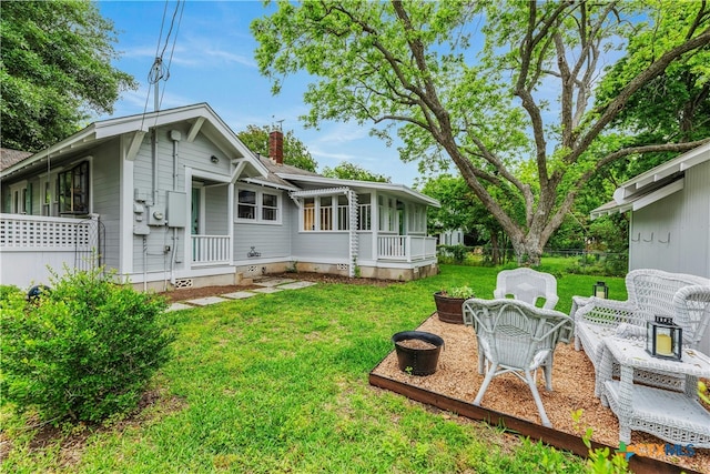 view of yard featuring covered porch