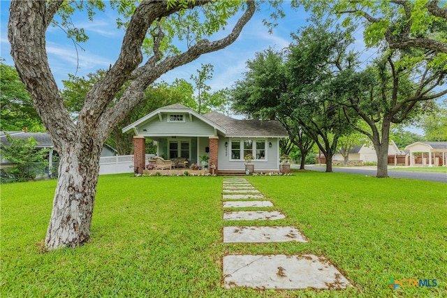 view of front of home featuring a front lawn and covered porch