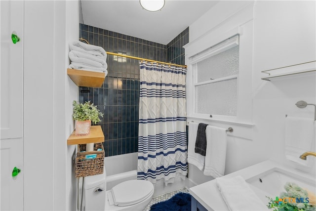 full bathroom with shower / bath combo with shower curtain, toilet, and vanity