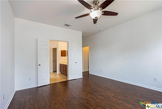 unfurnished bedroom featuring ensuite bath, ceiling fan, and light wood-type flooring