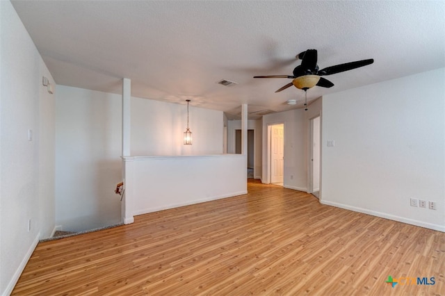 unfurnished room featuring ceiling fan, a textured ceiling, and light wood-type flooring