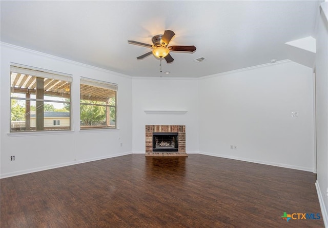 unfurnished living room featuring crown molding, dark hardwood / wood-style floors, and a brick fireplace