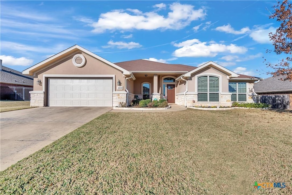 view of front facade with a front lawn and a garage