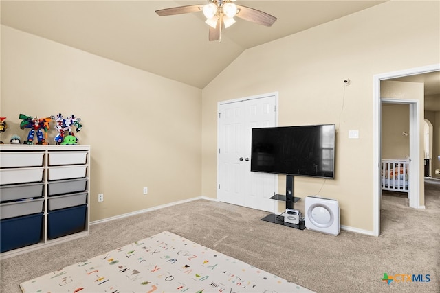 unfurnished bedroom featuring lofted ceiling, light carpet, and ceiling fan