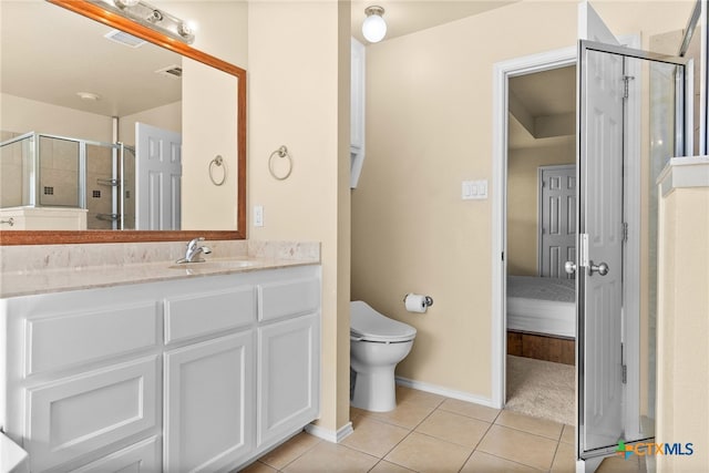 bathroom with vanity, a shower with shower door, tile patterned flooring, and toilet