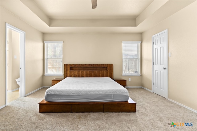 bedroom with ceiling fan, multiple windows, and light carpet