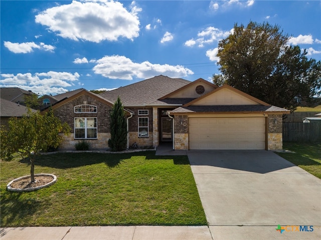 single story home featuring a garage and a front lawn