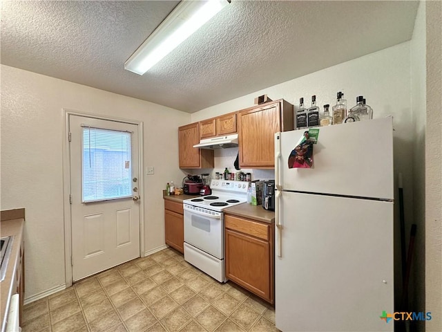 kitchen featuring white appliances and a textured ceiling