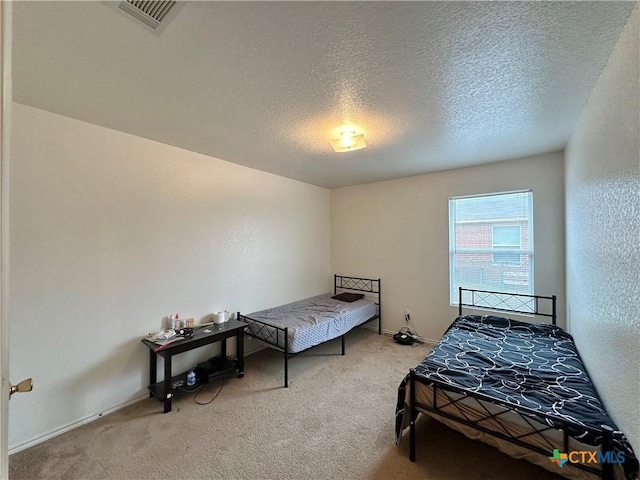 carpeted bedroom featuring a textured ceiling