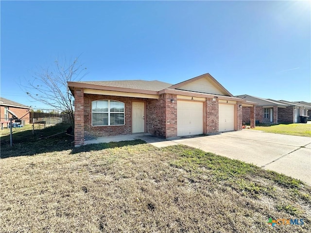 single story home featuring a garage and a front yard