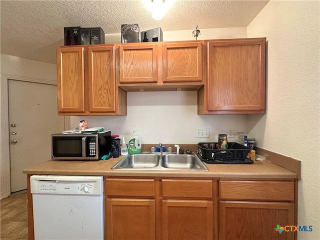 kitchen featuring dishwasher, a textured ceiling, and sink