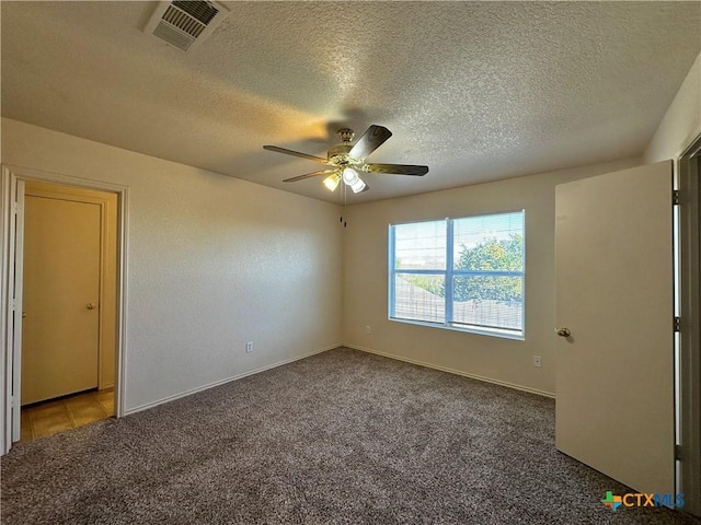 carpeted empty room featuring a textured ceiling and ceiling fan