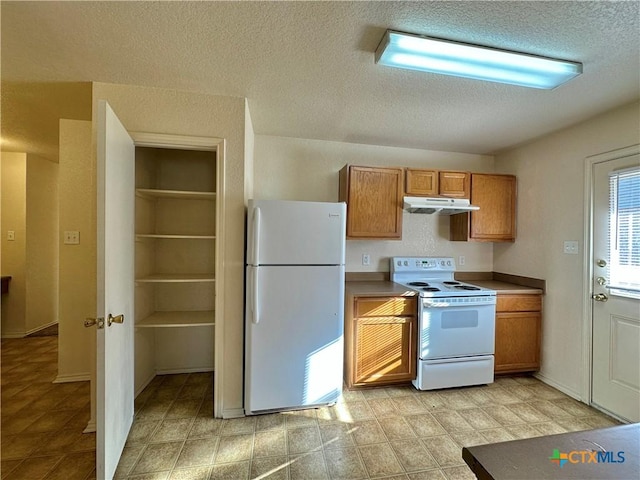 kitchen with white appliances and a textured ceiling