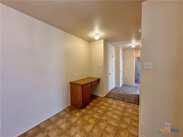 hall with a textured ceiling