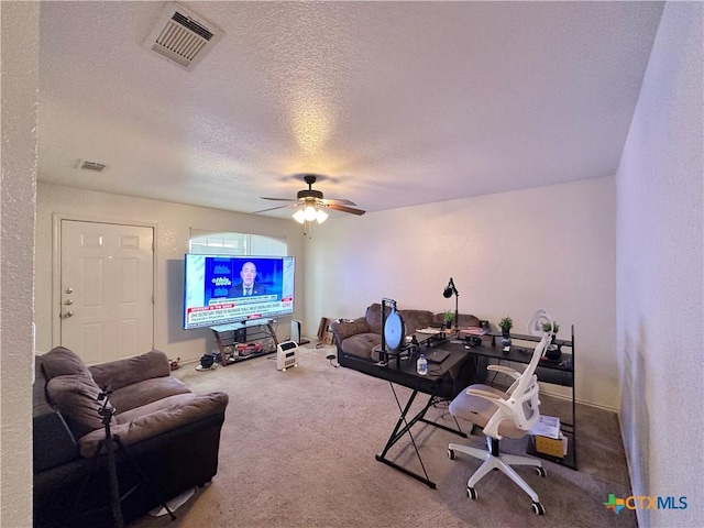 interior space with ceiling fan and a textured ceiling