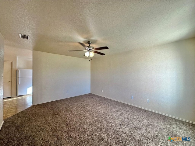 spare room with carpet flooring, a textured ceiling, and ceiling fan