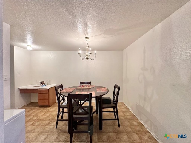 dining room with a notable chandelier and a textured ceiling