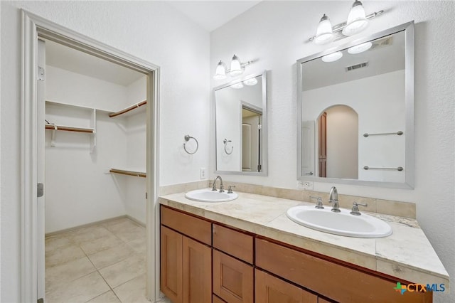 14424 Tuscola Cir, Austin, TX 78734 - bathroom featuring double vanity, tile patterned floors, and a spacious closet