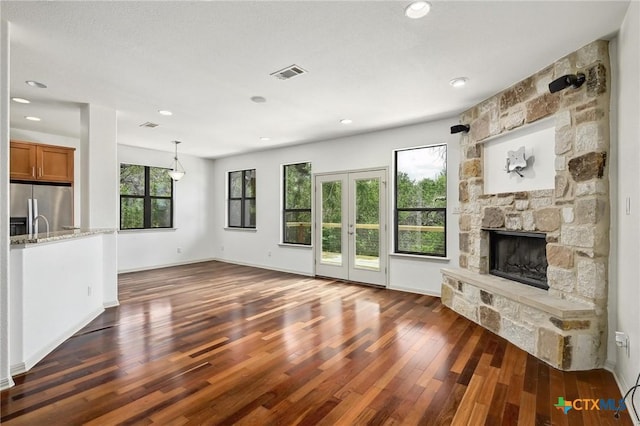 14424 Tuscola Cir, Austin, TX 78734 - unfurnished living room featuring dark wood-style floors, a fireplace, recessed lighting, and french doors
