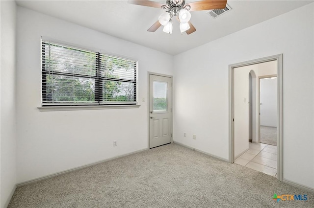 14424 Tuscola Cir, Austin, TX 78734 - unfurnished room featuring light colored carpet, a ceiling fan, and arched walkways