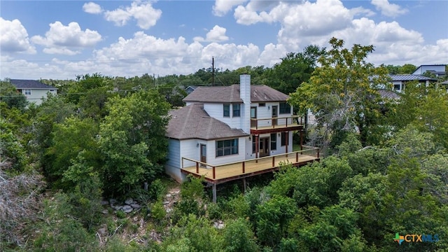 14424 Tuscola Cir, Austin, TX 78734 - back of house featuring a wooden deck, a balcony, roof with shingles, and a chimney