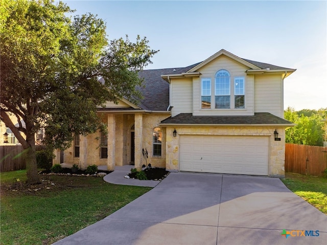 view of front of home featuring a front yard and a garage