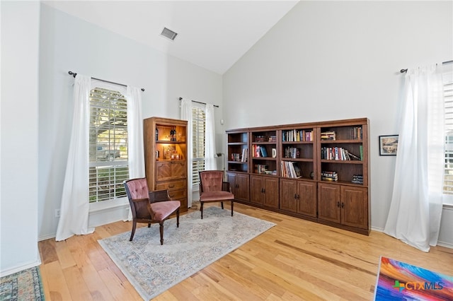 sitting room featuring light hardwood / wood-style floors and high vaulted ceiling