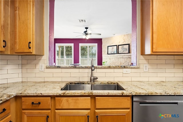 kitchen with dishwasher, decorative backsplash, ceiling fan, and sink