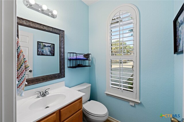 bathroom with vanity and toilet