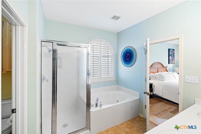 bathroom with tile patterned flooring, vanity, and shower with separate bathtub