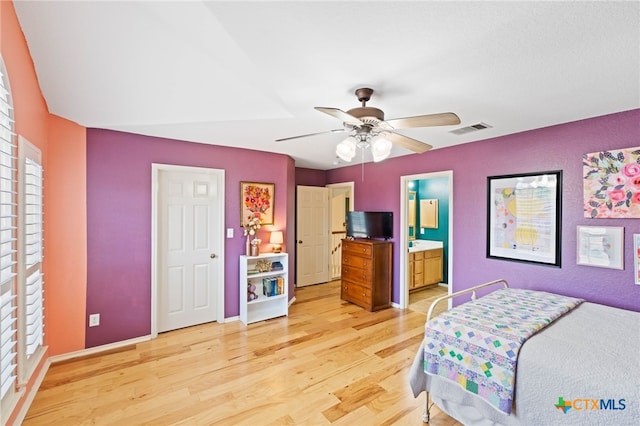 bedroom featuring ceiling fan, light wood-type flooring, and ensuite bathroom