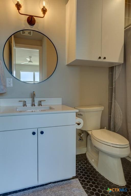 bathroom with tile patterned floors, vanity, and toilet