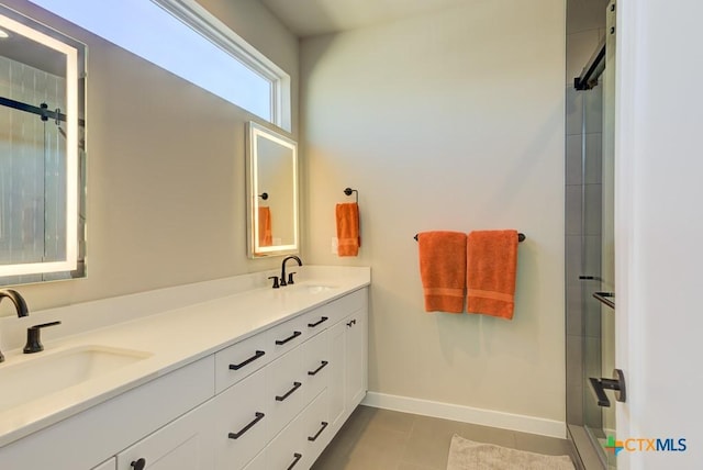 bathroom featuring vanity, tile patterned flooring, and a shower with door