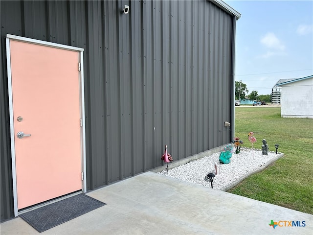 view of outdoor structure featuring a lawn