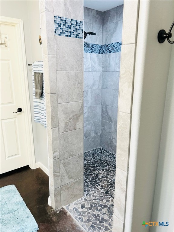 bathroom with a tile shower